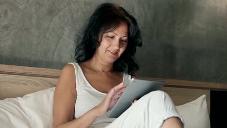 Attractive-woman-using-her-digital-tablet