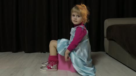 Little-girl-sitting-on-the-potty-and-watching-TV