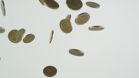 Euro-coins-falling-down-in-slowmotion-in-front-of-white-background