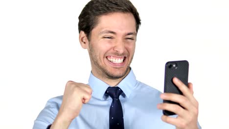 Joven-empresario-celebrando-el-éxito-durante-el-uso-de-smartphone-sobre-fondo-blanco