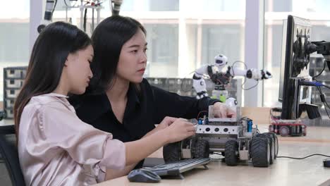 Female-electronics-engineer-try-to-fix-robot-at-lab.-Technology-and-innovation-concept.