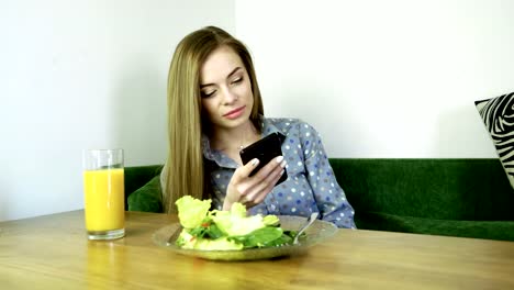 Attractive-young-happy-woman-using-mobile-phone-during-resting-in-a-cafe.-4K