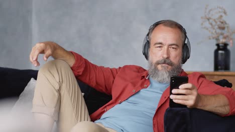 Retired-Man-Relaxing-and-Listening-to-Audio-Book