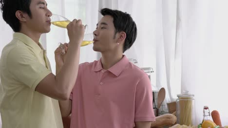 Asian-couple-gay-celebrating-at-home.-Gay-boy-drinking-beverage-for-happy-emotion-love-anniversary-together.-Concept-of-lifestyle,-family,-gay-and-bisexual.