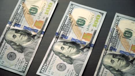 Us-dollar-bills-on-table-and-camera-is-sliding-slowly