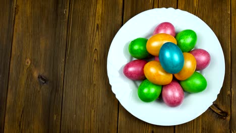 Man-puts-on-a-plate-the-Easter-dyed-and-painted-colored-eggs-during-a-Pascha-or-Resurrection-Sunday