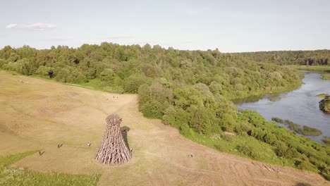 Aerial-view-of-the-Russian-forest,-river-and-steppe-overlooking-an-abandoned-Church-and-architectural-objects