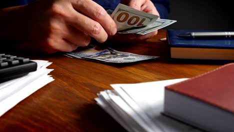 Close-up-of-hands-that-counting-money-in-the-office.