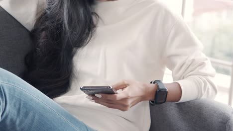 Close-up-asian-girl-using-smartphone-browsing-social-media-communication.