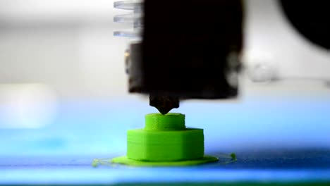 3D-printer-prints-green-shape-of-plastic-layers