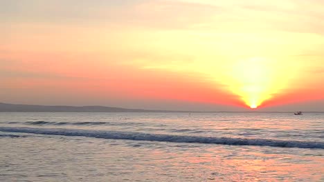 Boat-floating-in-ocean-horizon.-Ship-traveling-by-sea.-Golden-sunset-or-surise-sea-waves.-Summer-evening-or-morning-beautiful-scene-sea-panorama.-Sea-vessel-float-fishermans-go-home.-Red-gold-sun