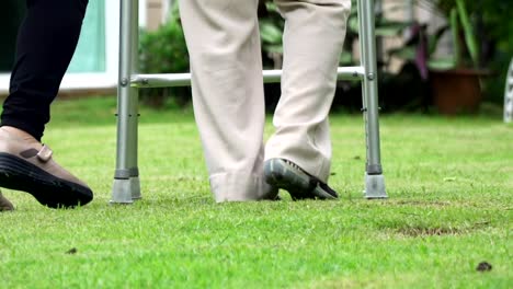 Elderly-woman-exercise-walking-in-backyard-with-daughter