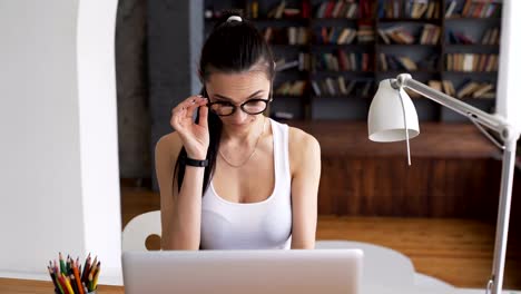 Smart-adult-female-work-by-computer-in-workspace