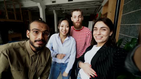 POV-of-happy-multi-ethnic-team-have-onlive-video-call-and-chatting-with-friends-in-modern-office