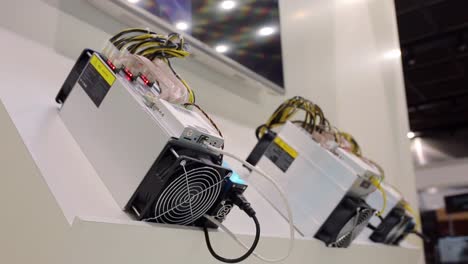 Cryptocurrency-mining-equipment---ASIC---application-specific-integrated-circuit-on-farm-stand-at-expo-or-exhibition