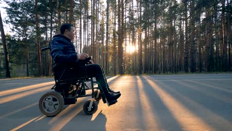 Disabled-person-rides-in-a-wheelchair-on-the-road.