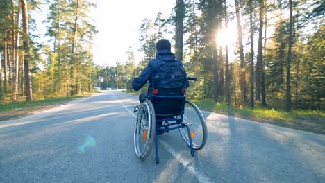 A-man-goes-in-a-wheelchair,-slow-motion.