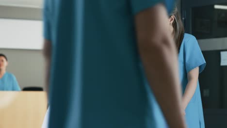 In-the-Hospital-Female-Doctor-Shows-Tablet-Computer-to-Elderly-Patient,-Explaining-his-Condition.-Modern-Hospital-with-Best-Possible-Care.