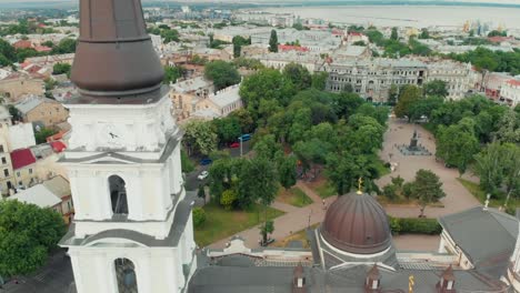 Old-european-city-aerial-sightseeing.-Flying-above-centre-district.-Drone-view.-Sea-on-horizon.-Close-up-ancient-christian-cathedral-building