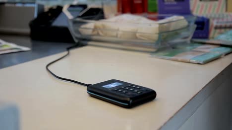 Close-up-of-bionic-hand-touching-payment-terminal