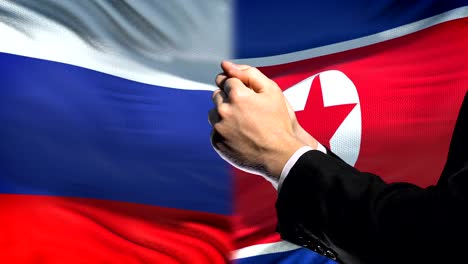 Russia-sanctions-North-Korea,-chained-arms,-political-or-economic-conflict