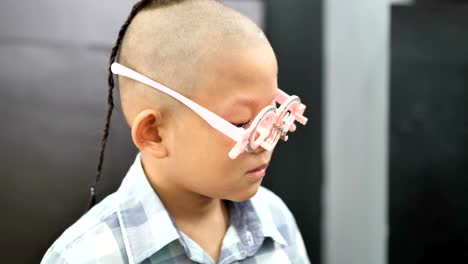 eyesight-check.-Asian-boys-who-have-vision-disabilities.-Left-eye-is-not-visible-from-brain-surgery.-Medical-treatment-and-Rehabilitation.-video-4k