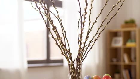 easter-eggs,-willow-and-candles-burning-at-home