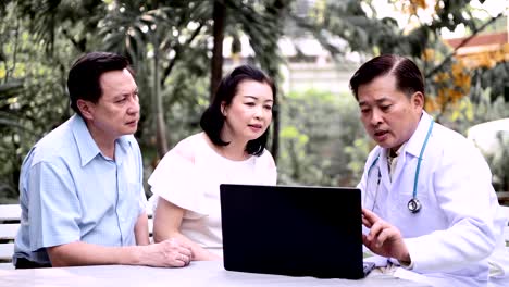 Doctor-and-patient-discussing-medical-examination-outdoor-in-garden.