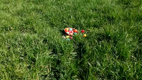 colorful-easter-eggs-in-the-fresh-spring-meadow,-aerial-view