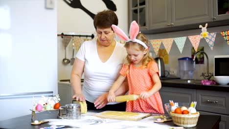 Little-Girl-Rolling-Out-a-Dough-with-Grandmother