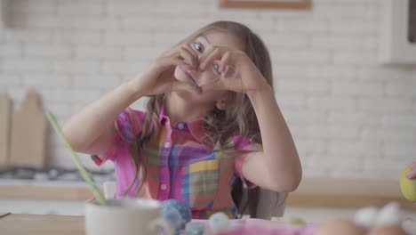 Cute-girl-showing-to-camera-hands-in-the-blue-paint.