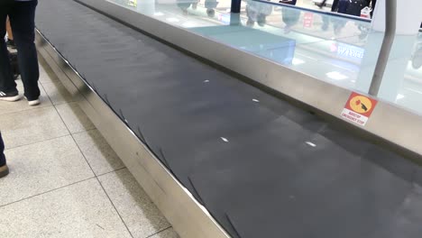 COPENHAGEN,-DENMARK---MARCH-2019:-Luggage-tape-in-the-airport-terminal.-Baggage-rides-on-the-issue-tape.-Baggage-claim