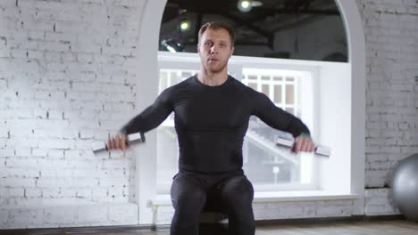 Male-Coach-Showing-Exercises-with-Dumbbells-on-Camera