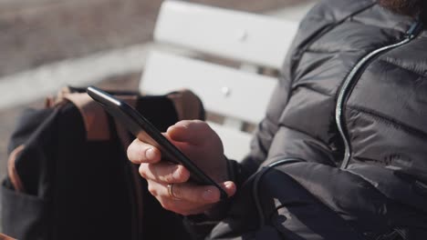 Man-is-swiping-screen-of-mobile-phone-by-fingers