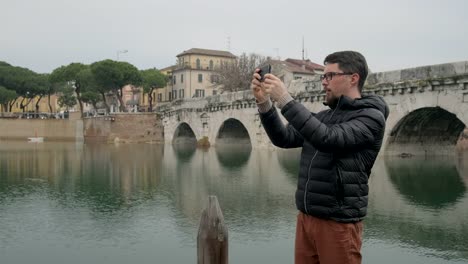 Man-is-photographing-downtown-by-smartphone