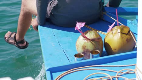 Half-view-of-a-man-sitting-on-the-edge-of-the-boat-in-a-journey-on-the-ocean