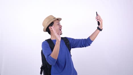 Asian-Thai-tourist-live-streaming-video-on-social-media-with-smart-phone-on-white-background