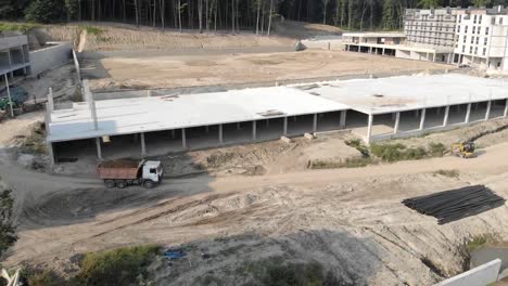 flying-over-a-brick-house-under-construction.-Construction-workers-build-a-house-of-brick.-New-house-aerial-view