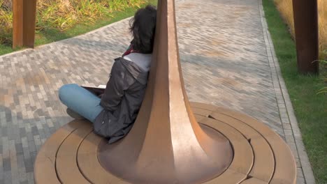 Caucasian-woman-closed-her-eyes-riding-on-carousel-circle-Book-lies-on-her-lap