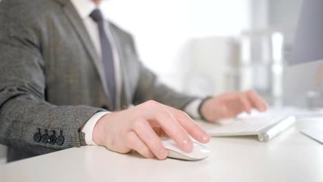 Close-up-of-man's-hands-using-desktop-computer