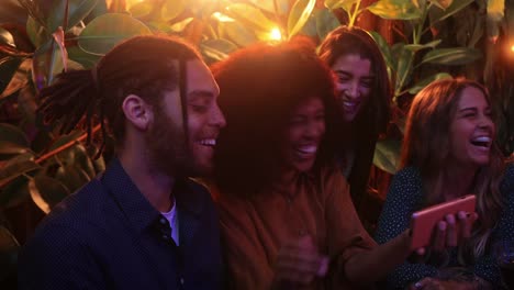 Close-up-black-woman-showing-video-on-smartphone-to-friends