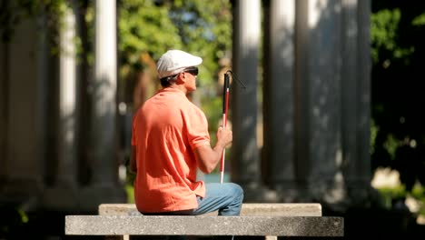 Blind-Man-Sitting-In-City-Park-And-Resting