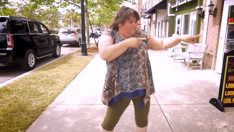 An-obese-woman-pointing-and-dancing-around-celebrating-success