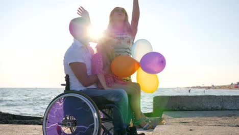 mom-and-father-hugging-daughter-in-backlight,-parents-with-child-on-open-air,-happy-daughter-sitting-on-dad