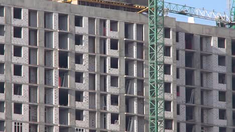 Construction-of-a-high-rise-apartment-house.-The-construction-crane-works-at-the-construction-site.-Construction-of-new-residential-property