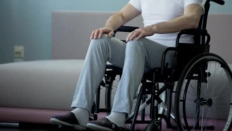 Lonely-old-man-with-disabilities-sadly-looking-out-window,-sitting-in-wheelchair