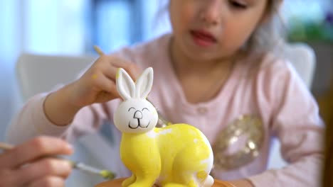 Happy-Easter!-Mother-and-her-daughter-with-Bunny-ears-painting-Easter-Bunny