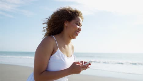 Voluptuous-Ethnic-female-laughing-and-walking-on-beach