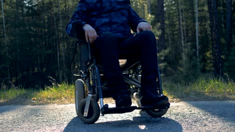 One-man-in-a-modern-wheelchair,-close-up.