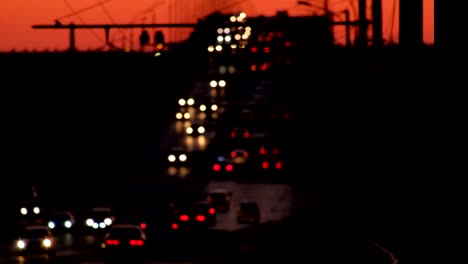 Night-traffic-defocused.-Many-cars-moving-along-bridge